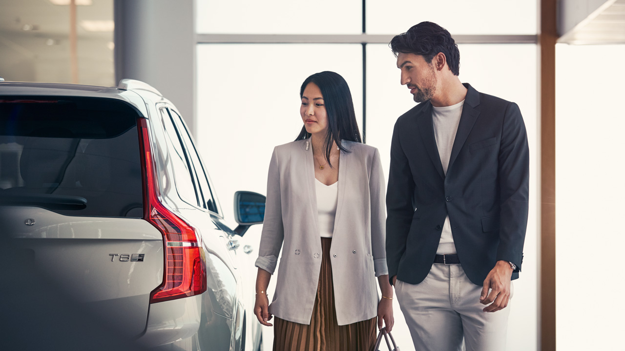 Couple in dealership looking at Volvo