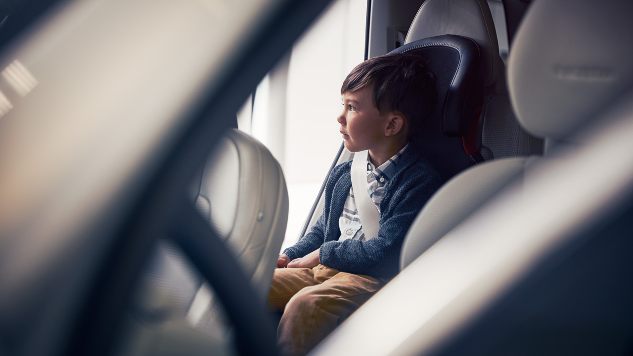 Kid sitting inside Volvo at dealership