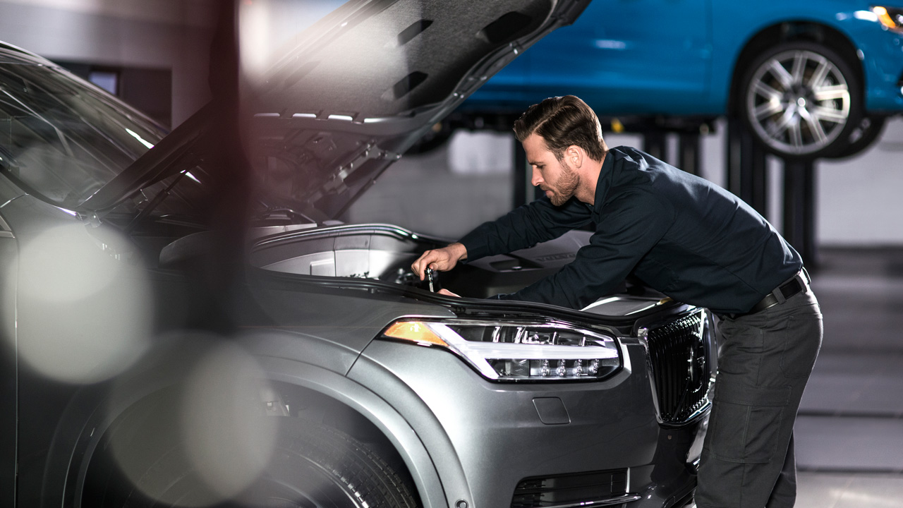 Volvo Service Technician under hood