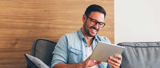 Happy man on his tablet