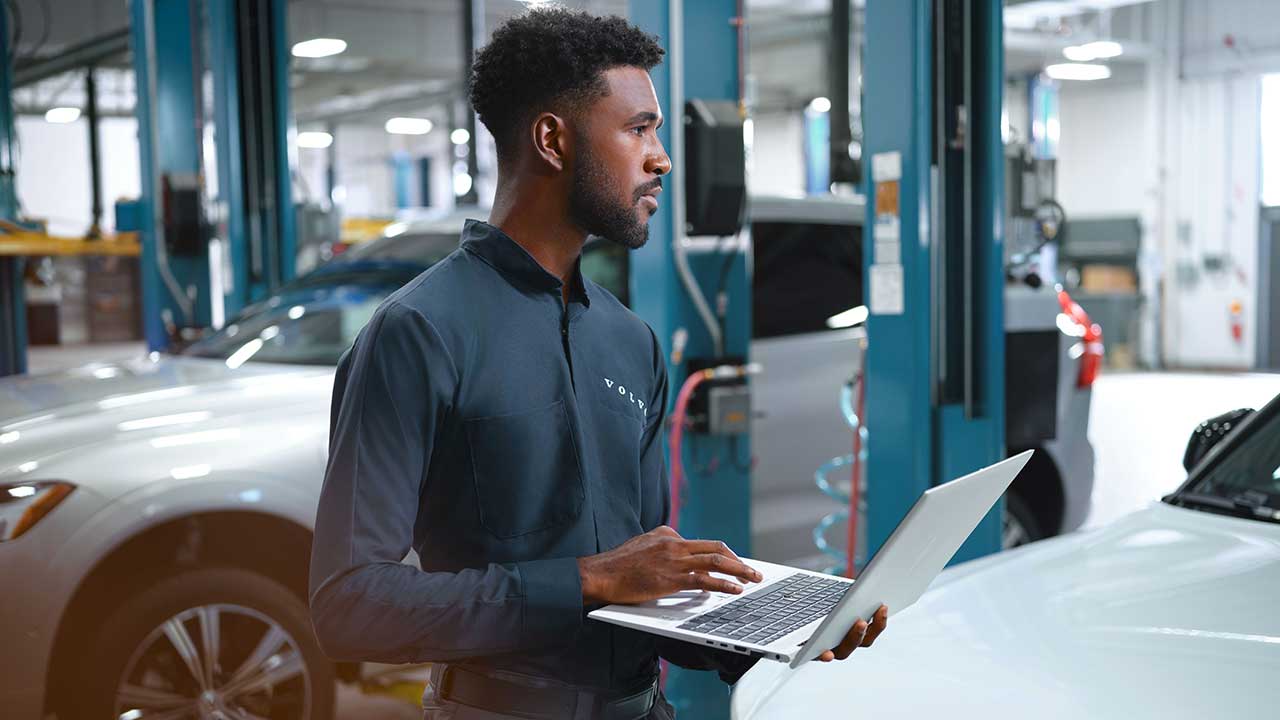 Service tech in bay with laptop