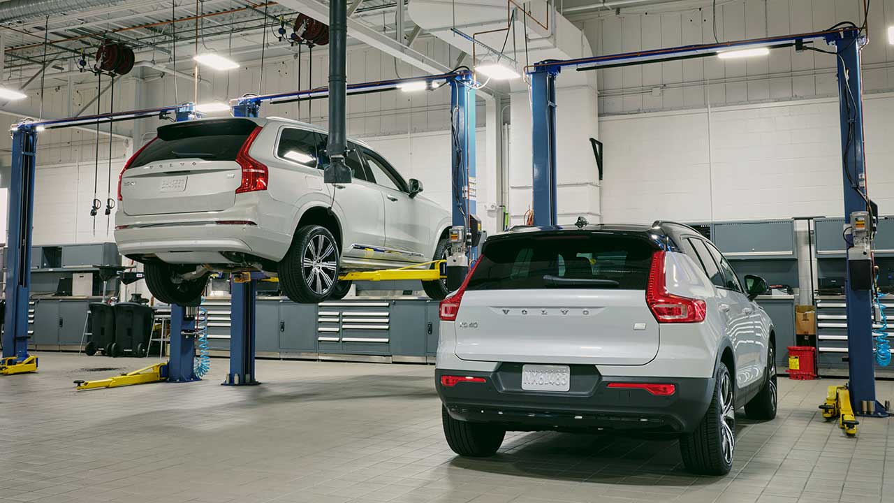 Wide shot of a service bay with 2 Volvos
