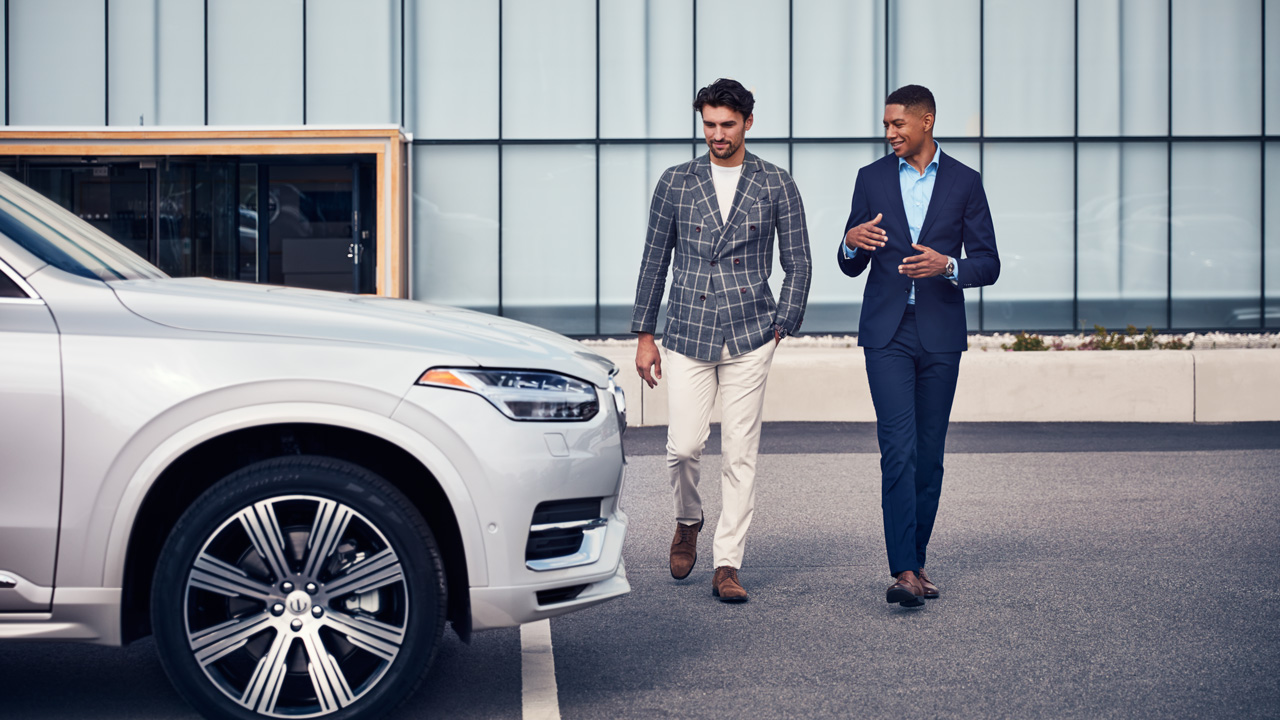 Two men outside dealership