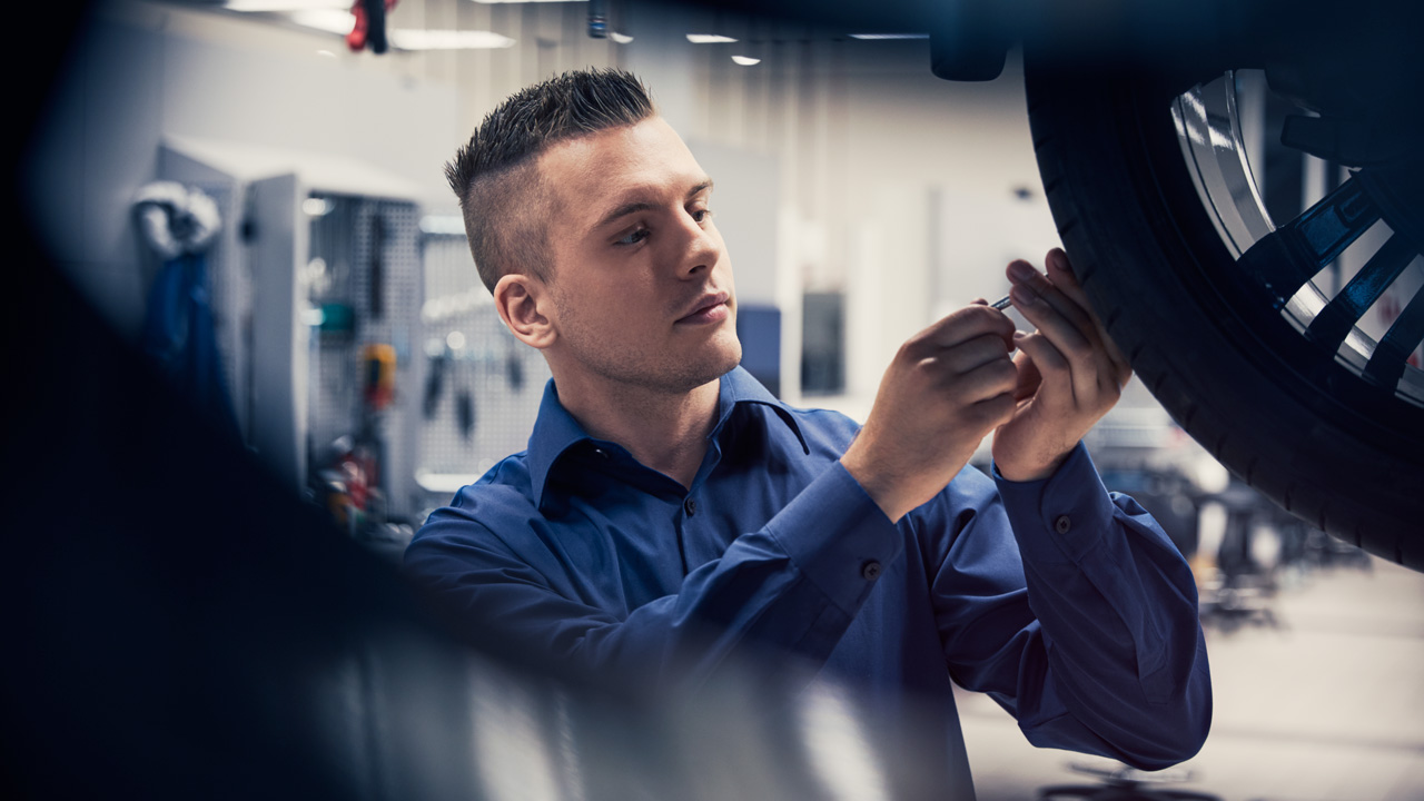 Volvo technician fixing wheel